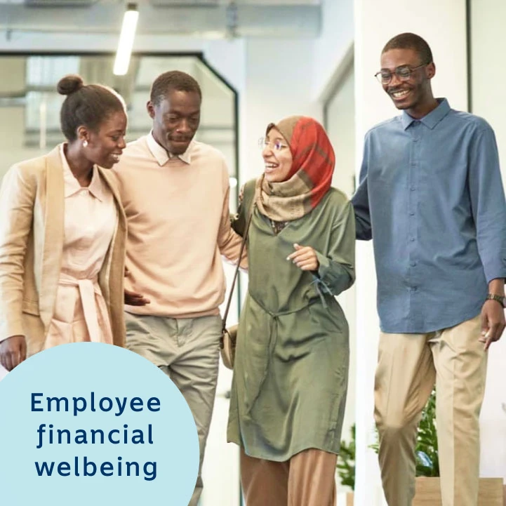 A diverse group of smiling colleagues walking together in a modern office, with a label that reads 